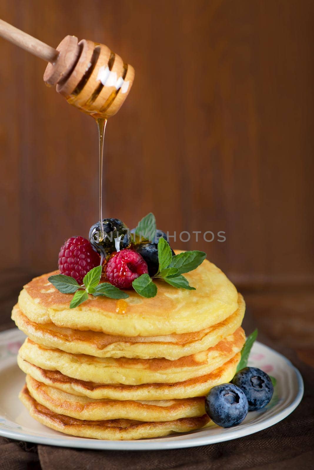 Stack of pancakes with fresh berries, close-up. by aprilphoto