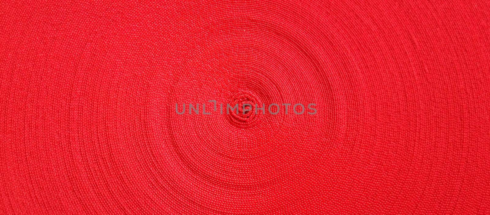 Red abstract circular pattern made of red sling.