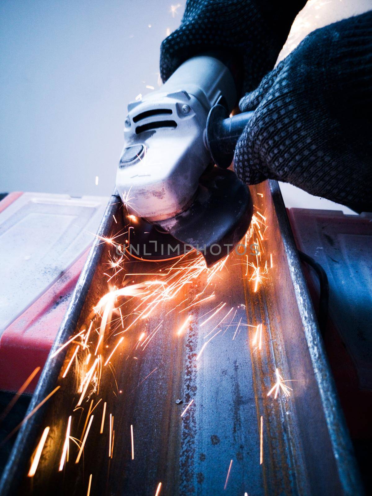 Sawing metal with circular saw sparks close up