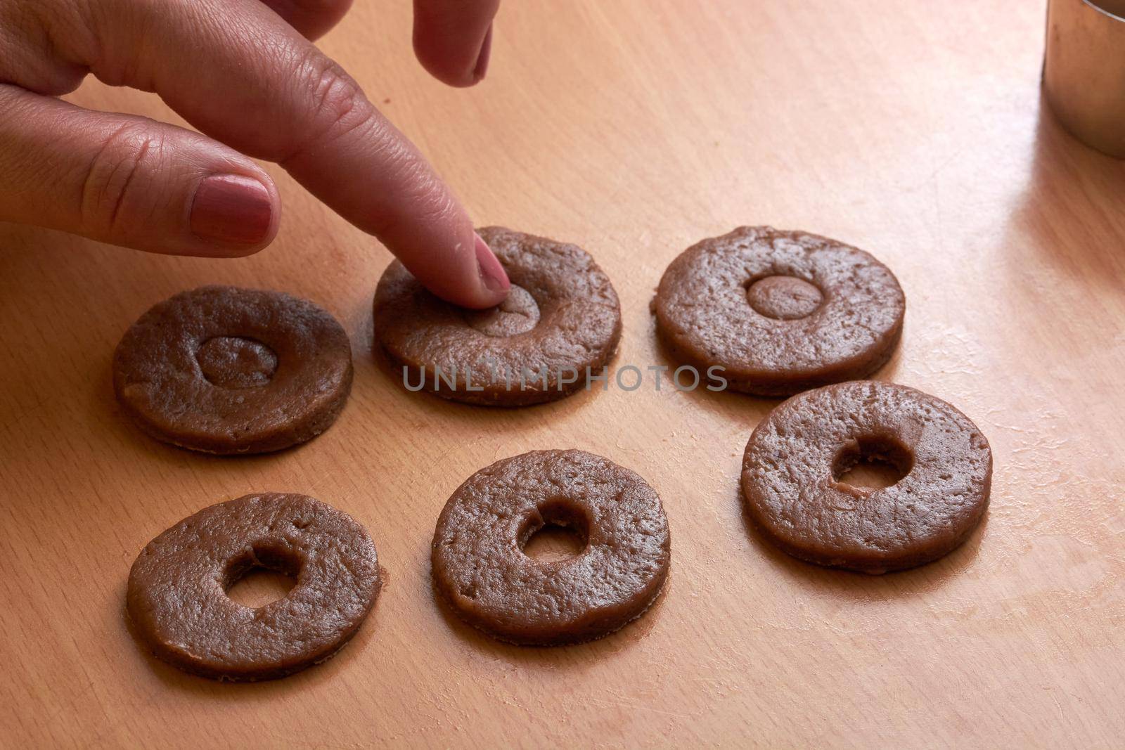 Cutting cookies from the dough and preparing for bake in the electrical stowe