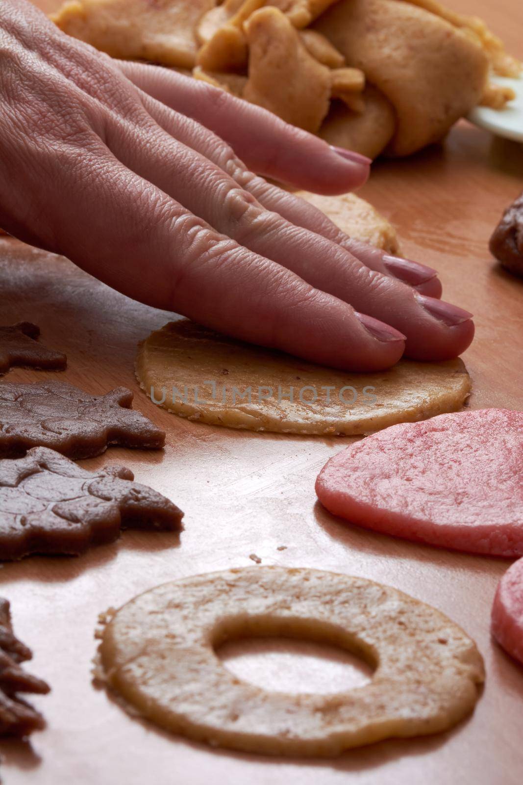 Cutting cookies from the dough and preparing for bake in the electrical stowe