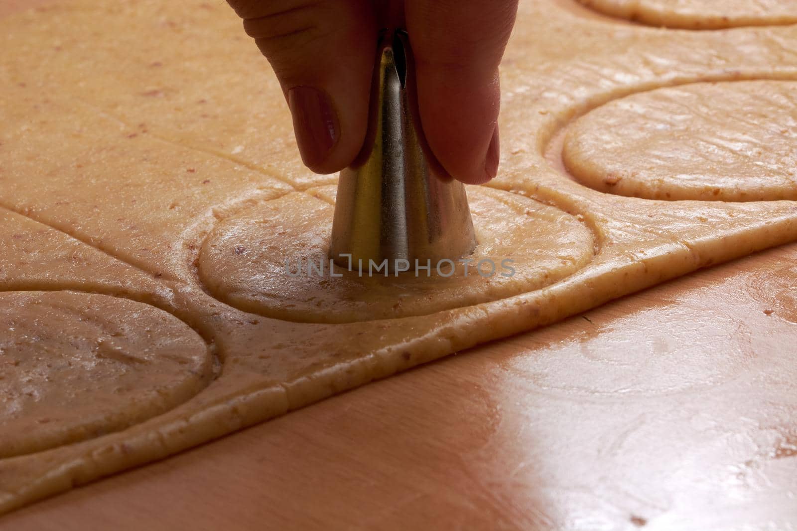 Cutting cookies from the dough and preparing for bake in the electrical stowe