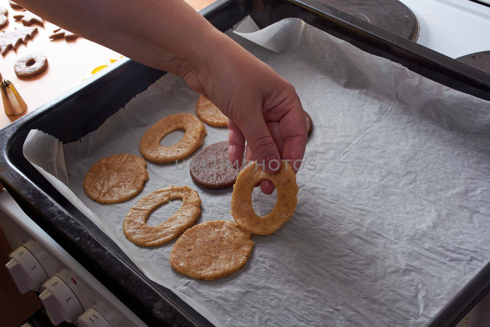 Cutting cookies from the dough and preparing for bake in the electrical stowe