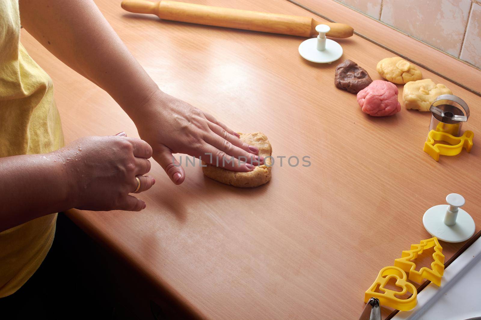 Cutting cookies from the dough and preparing for bake in the electrical stowe