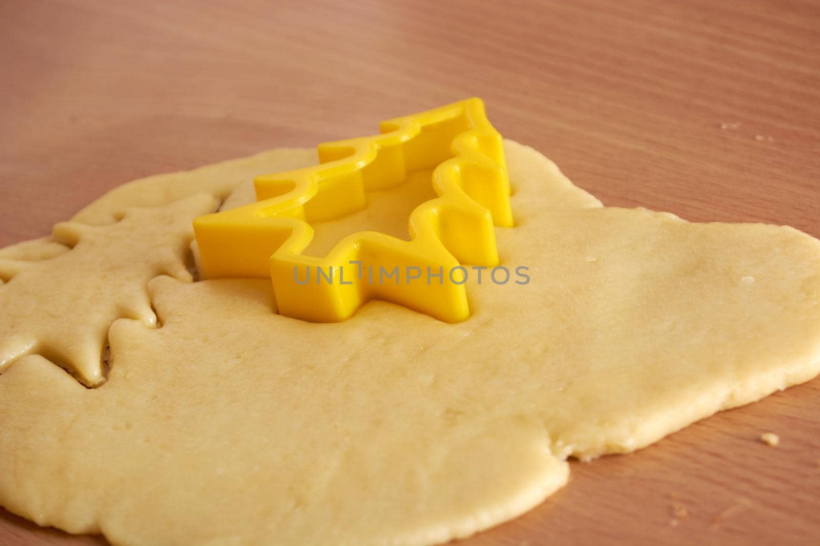 Cutting cookies from the dough and preparing for bake in the electrical stowe