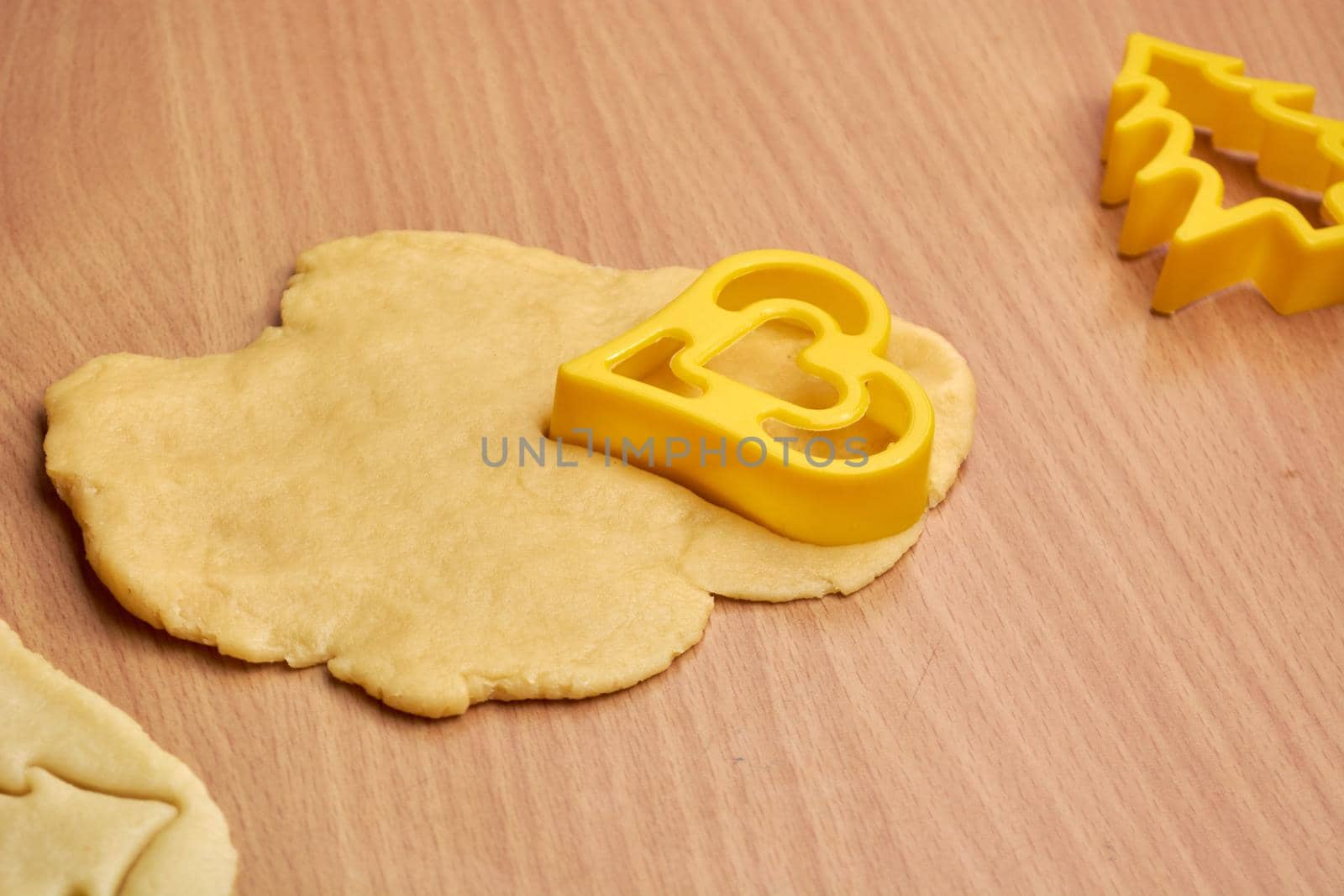 Cutting cookies from the dough and preparing for bake in the electrical stowe