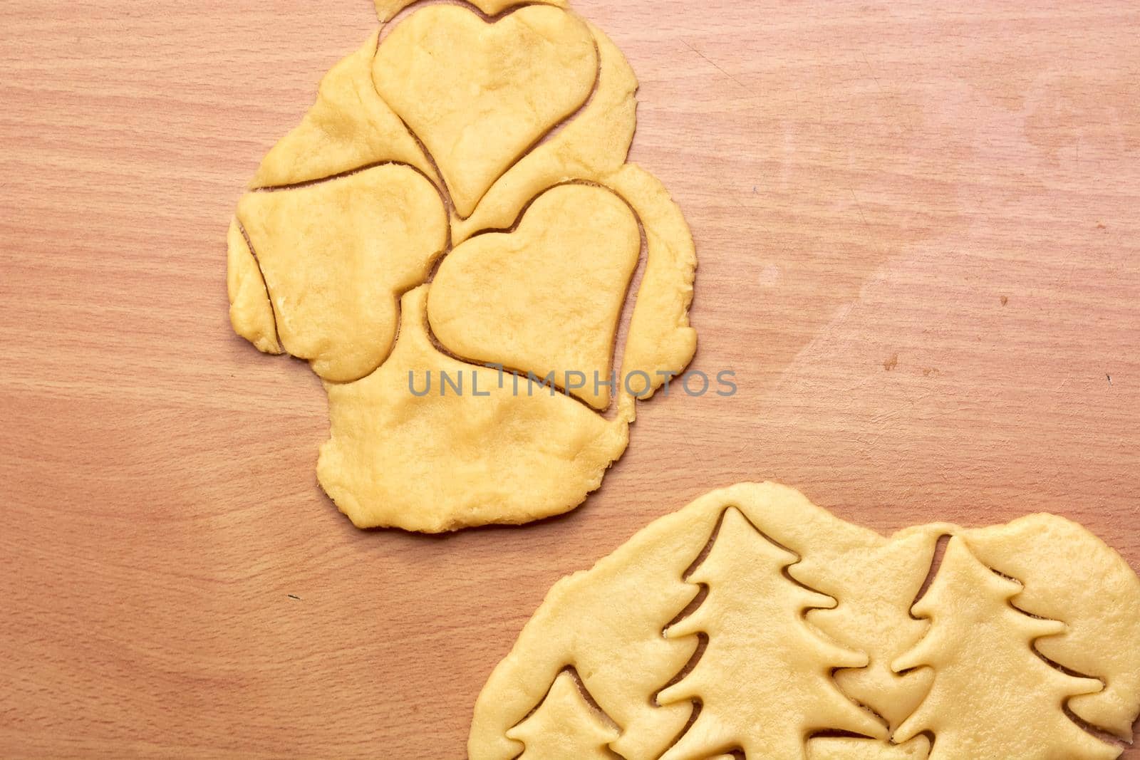 Cutting cookies from the dough and preparing for bake in the electrical stowe