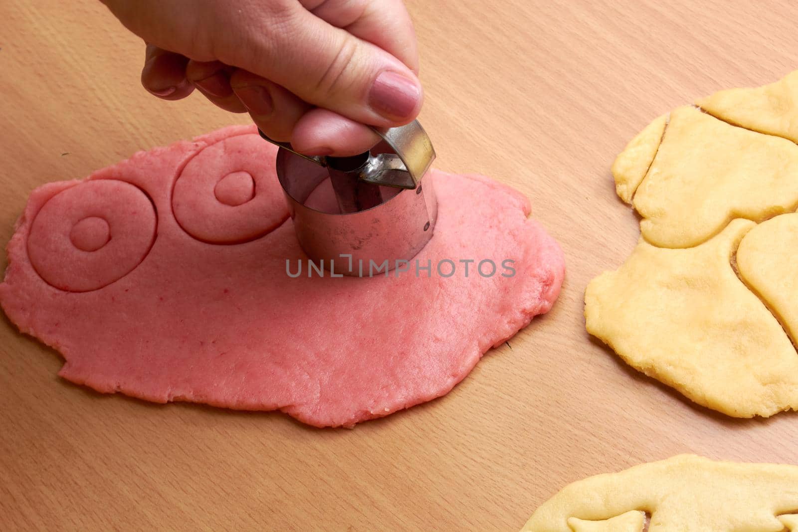 Cutting cookies from the dough and preparing for bake in the electrical stowe