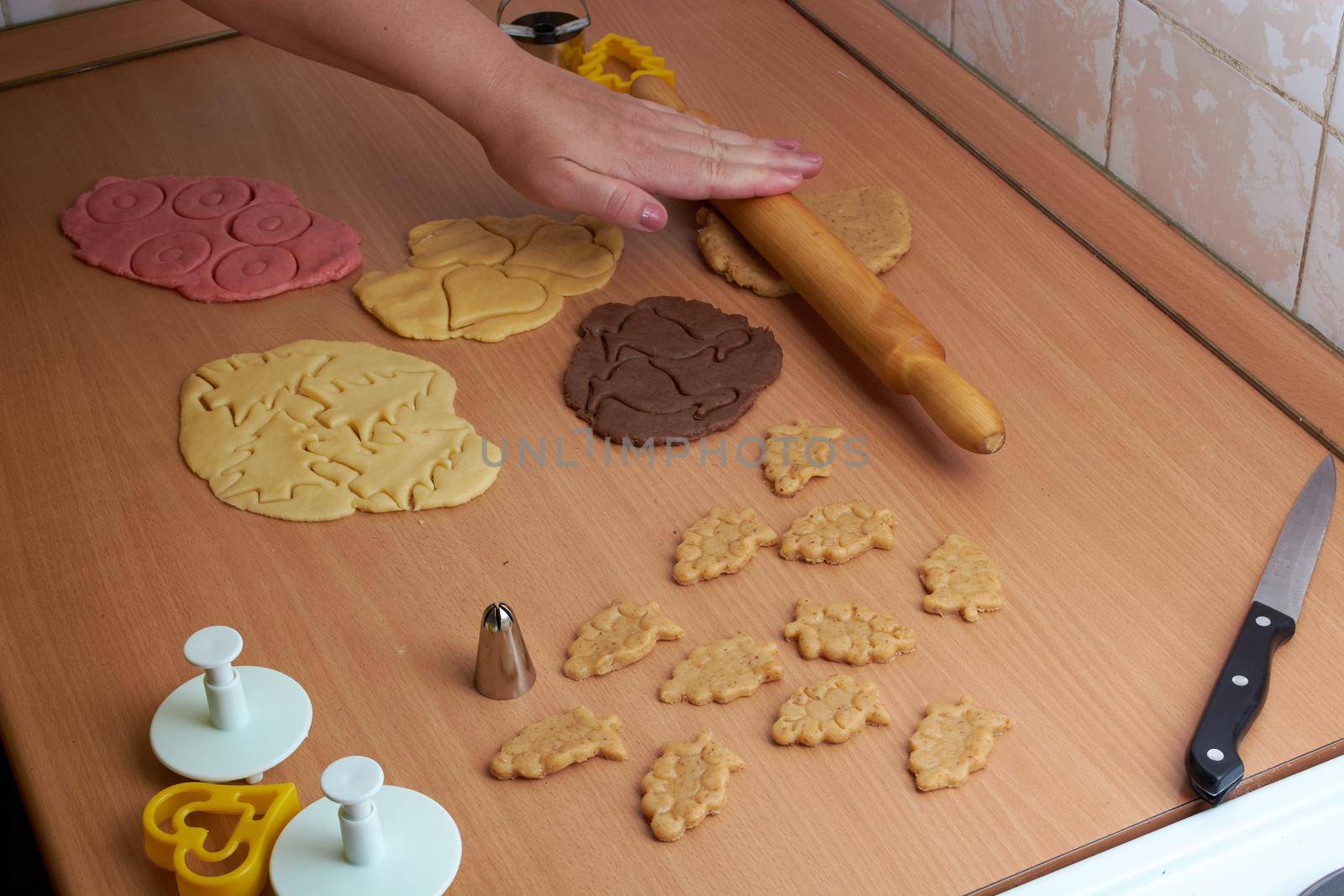 Cutting cookies from the dough and preparing for bake in the electrical stowe