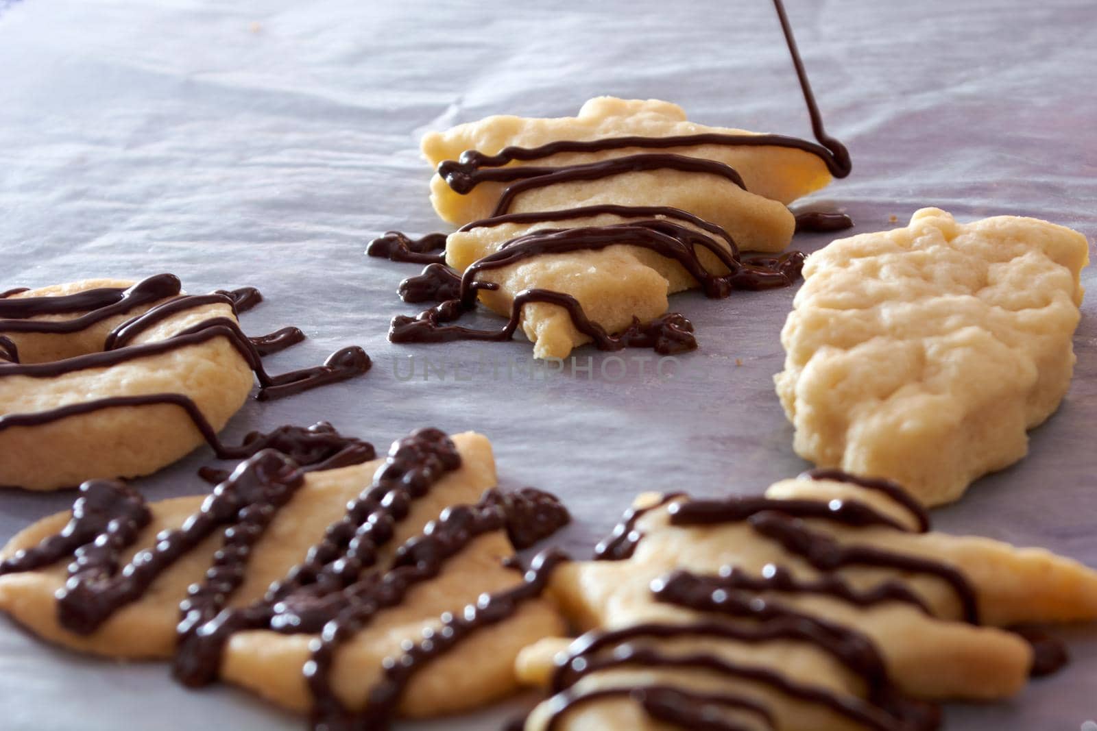 Pouring chocolate on just baked christmas cookies