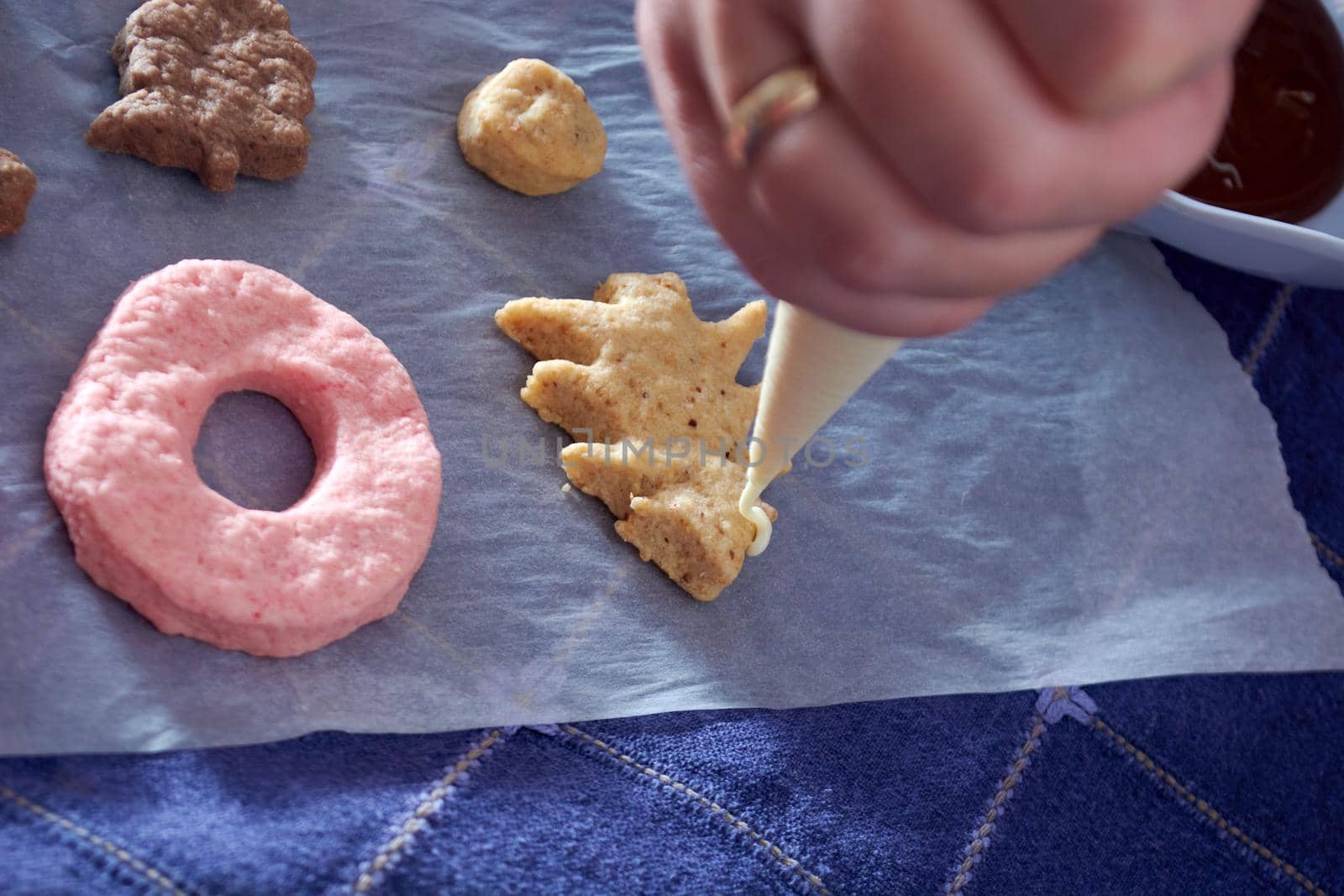 Pouring chocolate on just baked christmas cookies