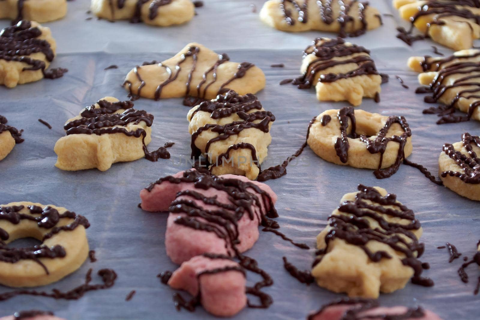 Pouring chocolate on just baked christmas cookies by radebg