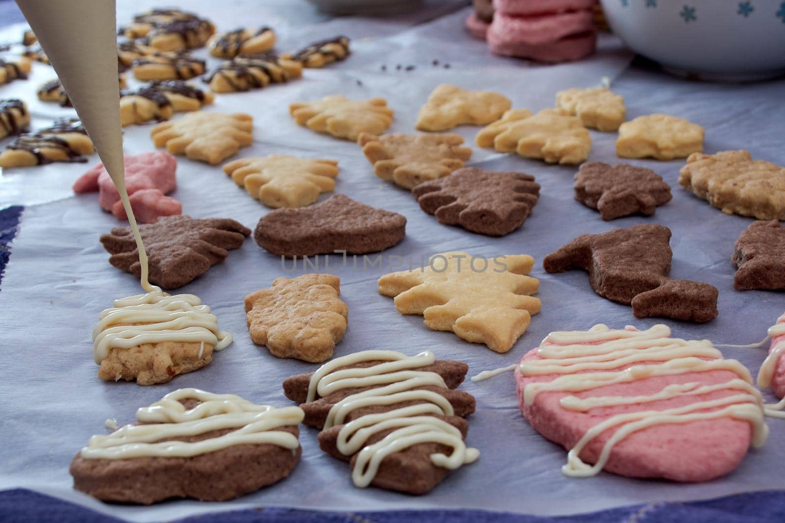 Pouring chocolate on just baked christmas cookies by radebg