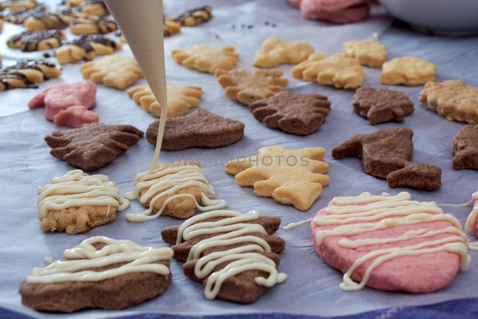 Pouring chocolate on just baked christmas cookies by radebg