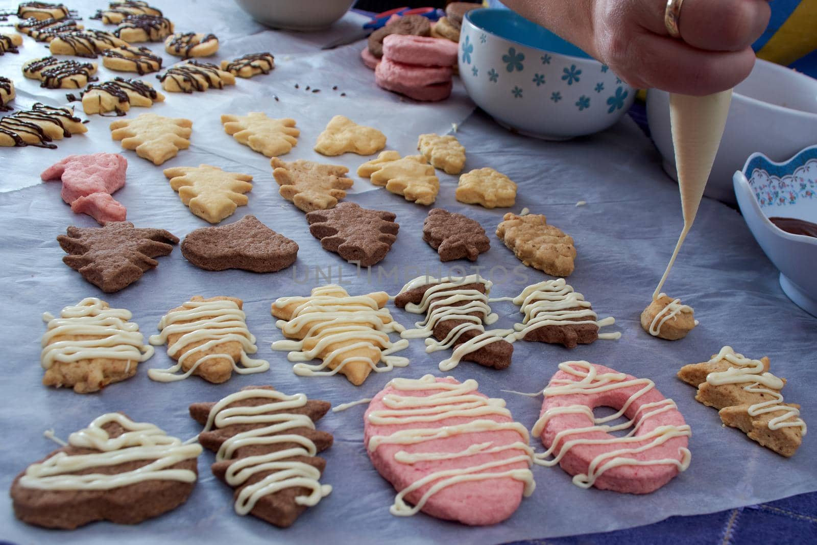 Pouring chocolate on just baked christmas cookies