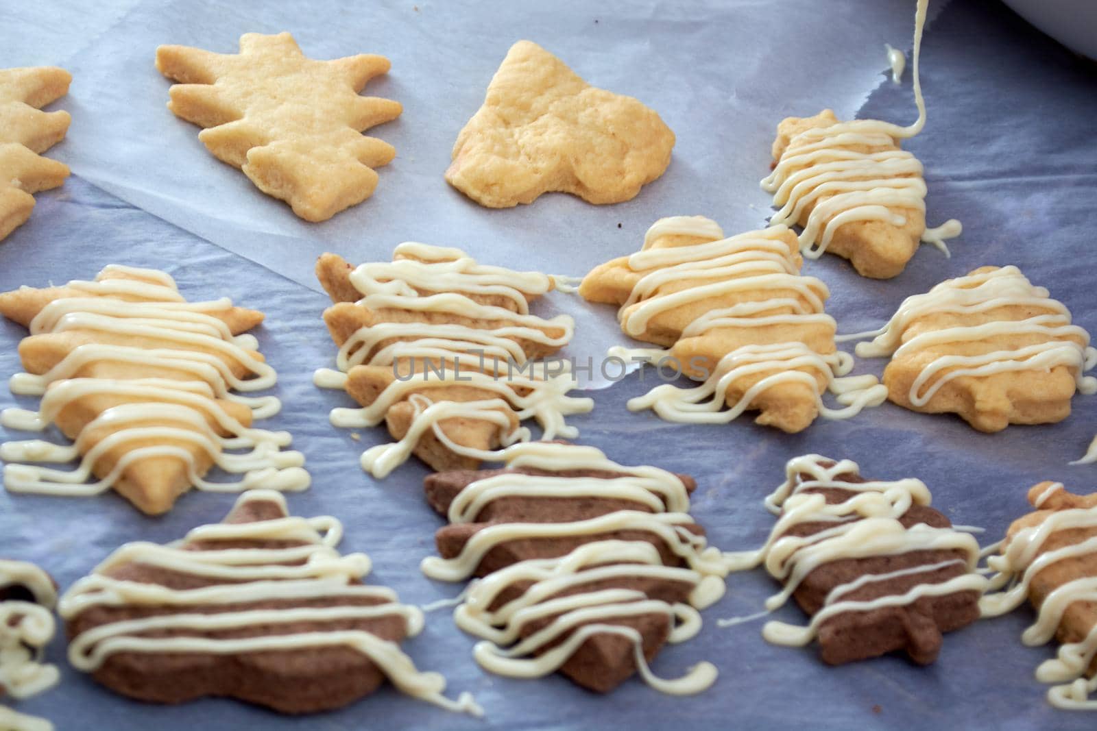 Pouring chocolate on just baked christmas cookies