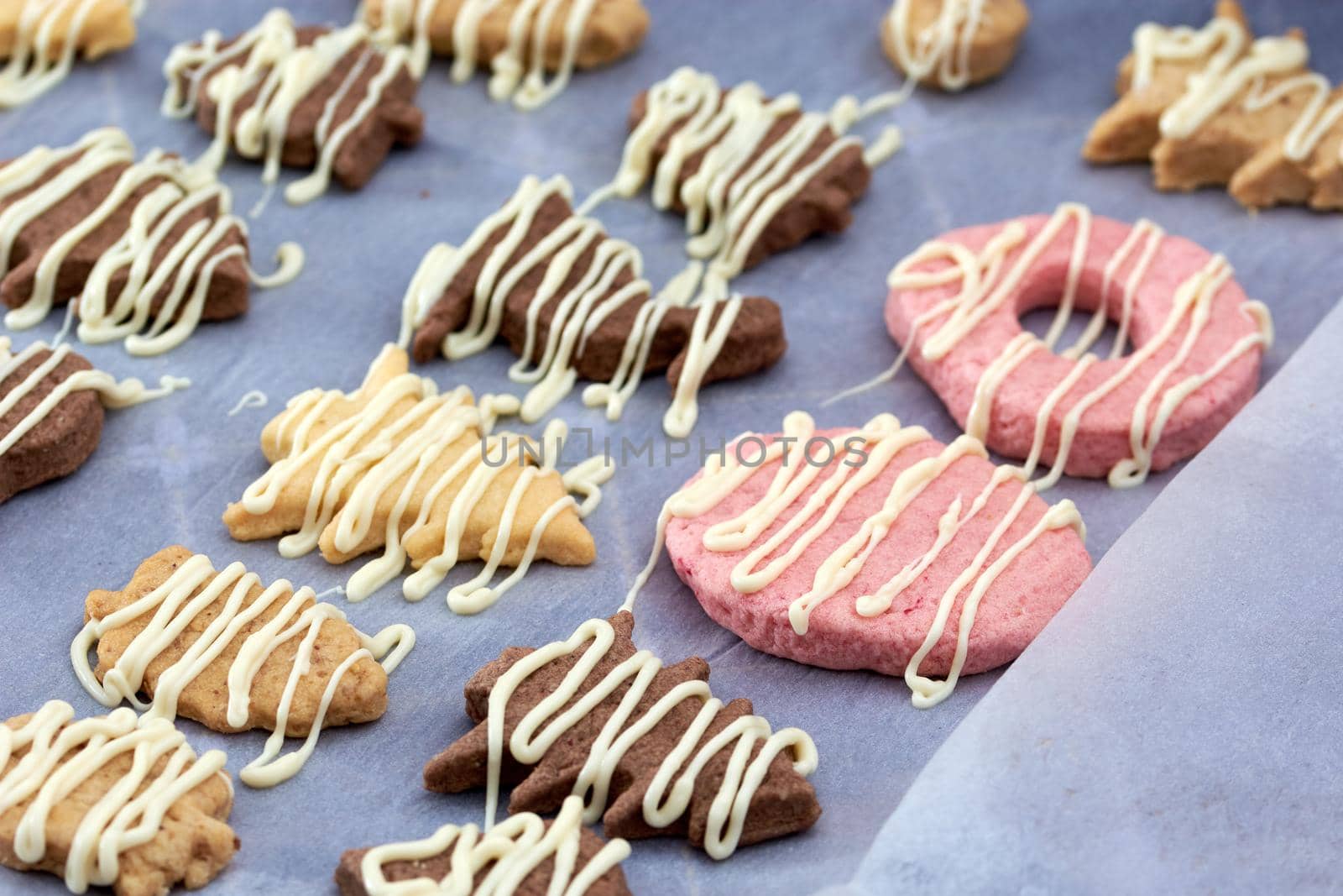 Pouring chocolate on just baked christmas cookies