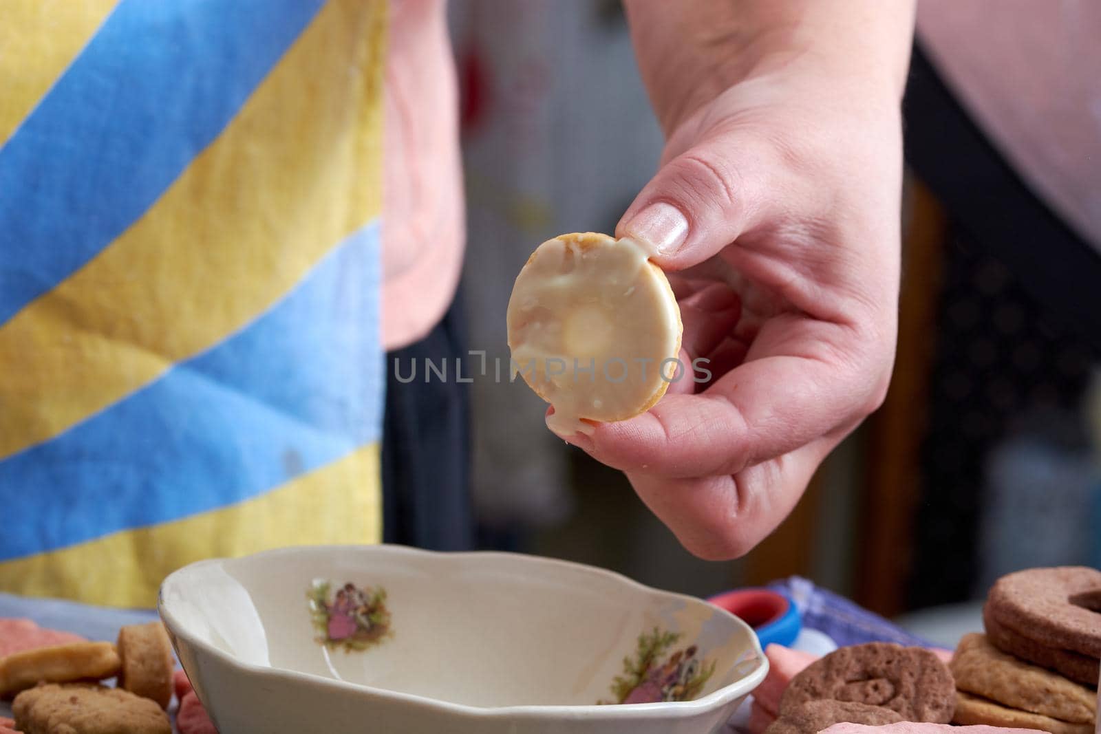 Pouring chocolate on just baked christmas cookies