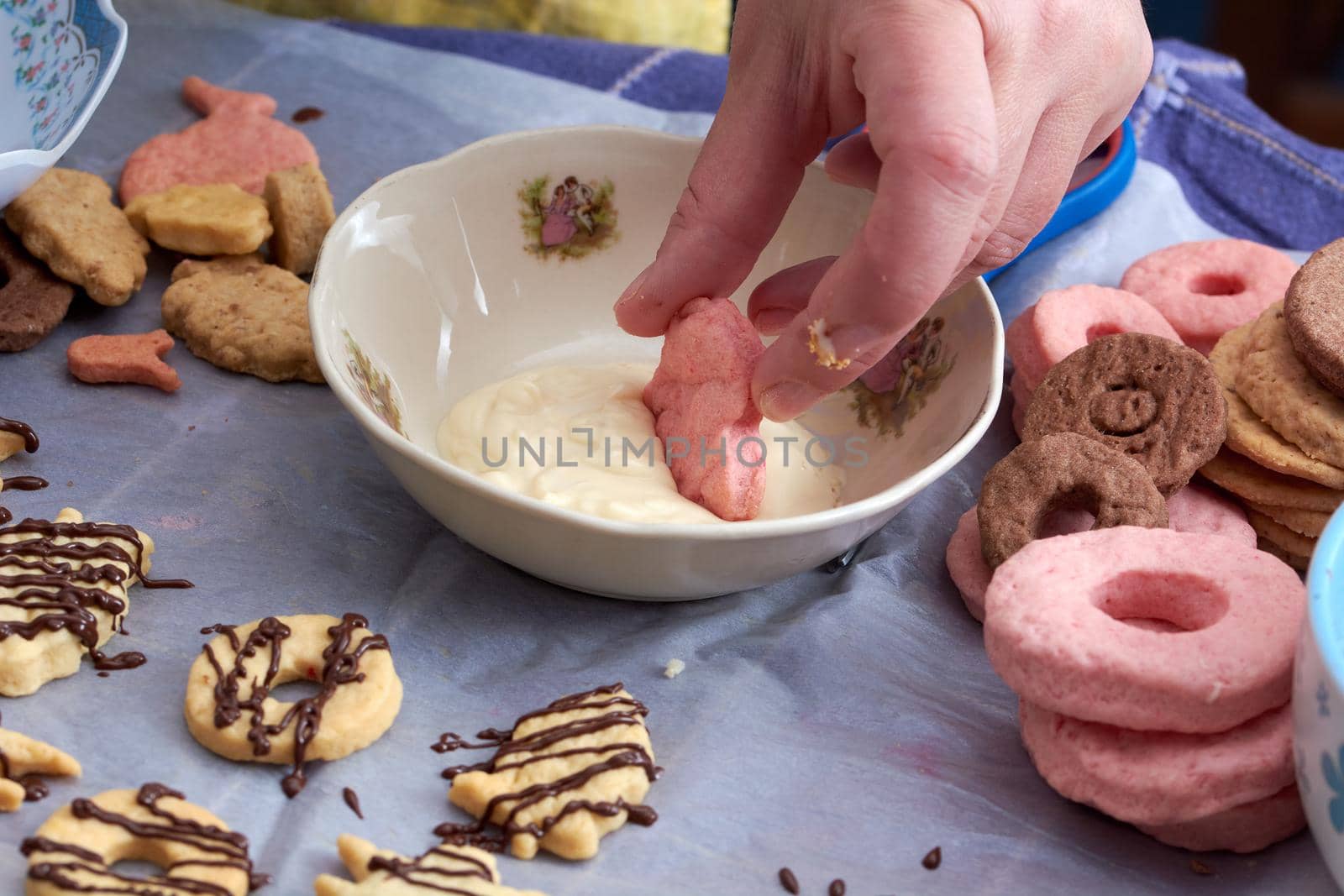 Pouring chocolate on just baked christmas cookies by radebg