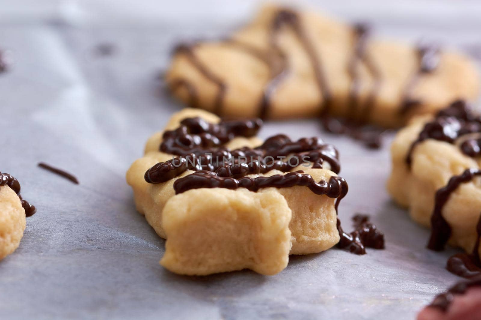 Pouring chocolate on just baked christmas cookies