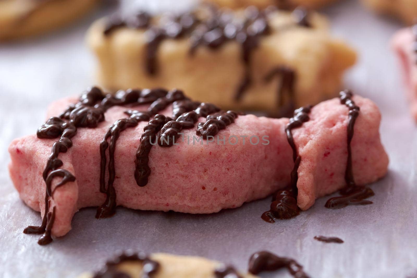 Pouring chocolate on just baked christmas cookies