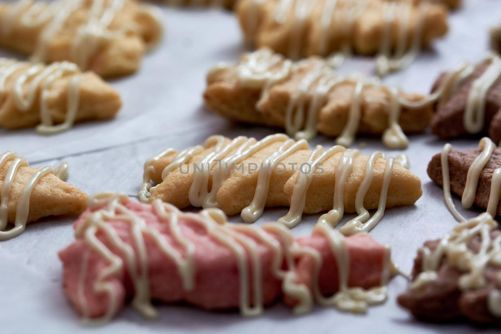 Pouring chocolate on just baked christmas cookies by radebg