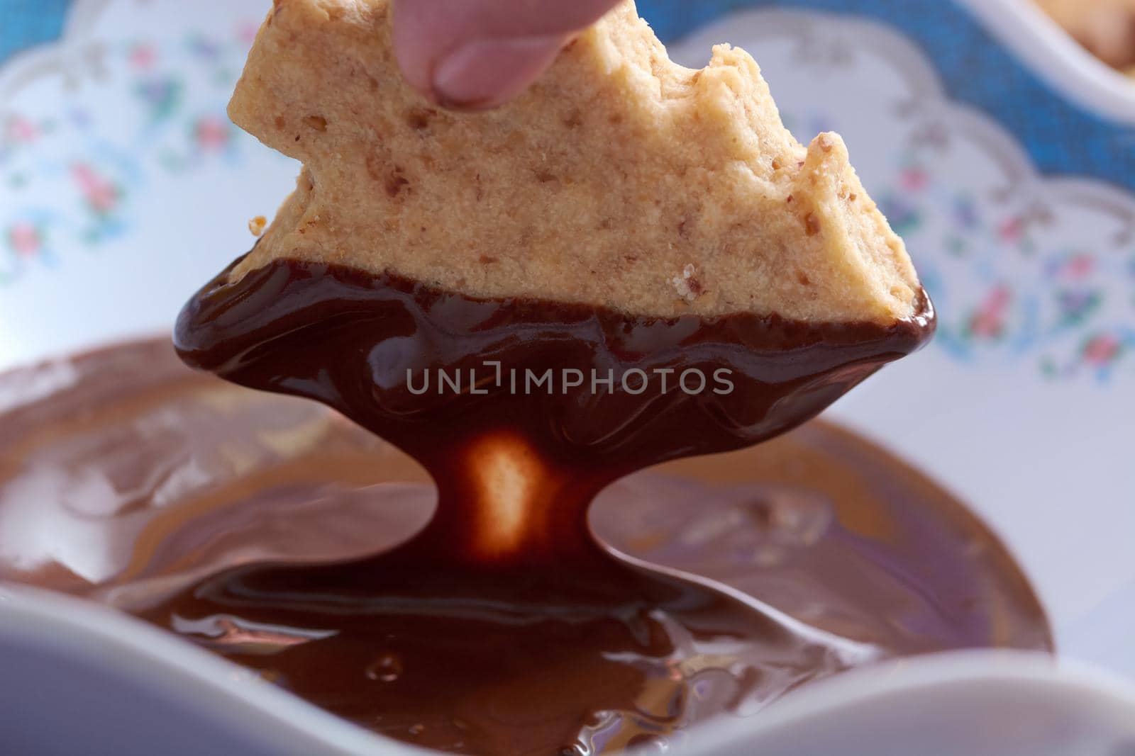 Pouring chocolate on just baked christmas cookies