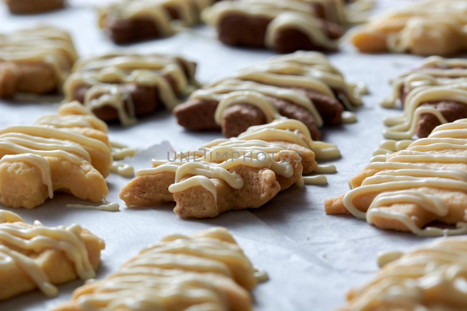 Pouring chocolate on just baked christmas cookies by radebg