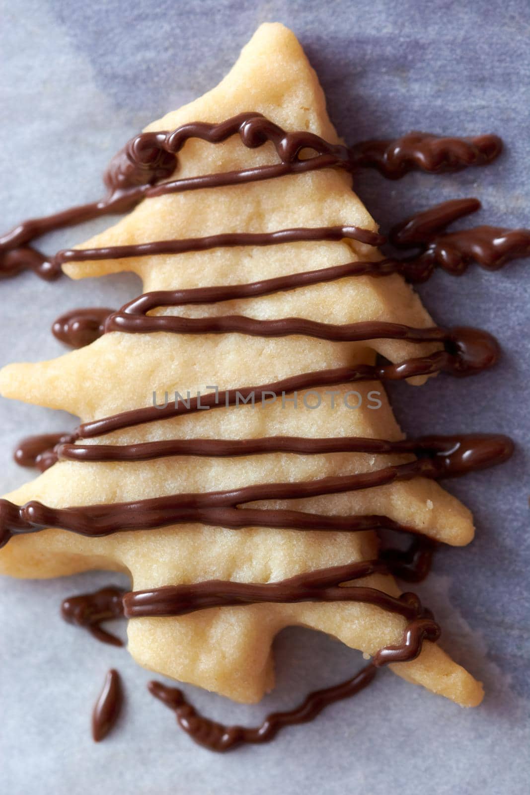 Pouring chocolate on just baked christmas cookies by radebg