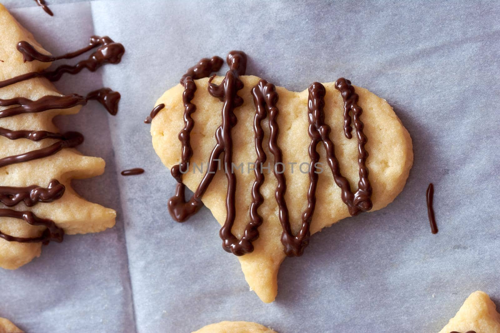 Pouring chocolate on just baked christmas cookies by radebg