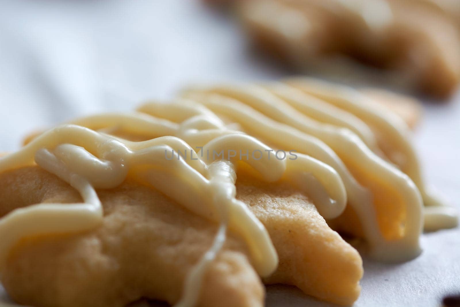 Pouring chocolate on just baked christmas cookies