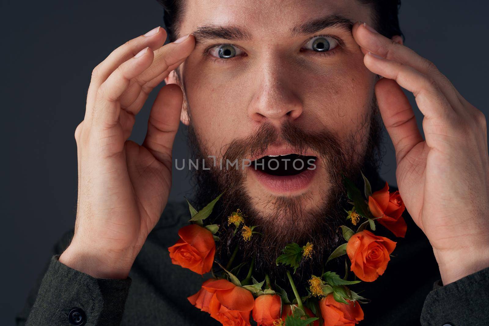 Portrait of a bearded man flowers decoration romance close-up black background by SHOTPRIME