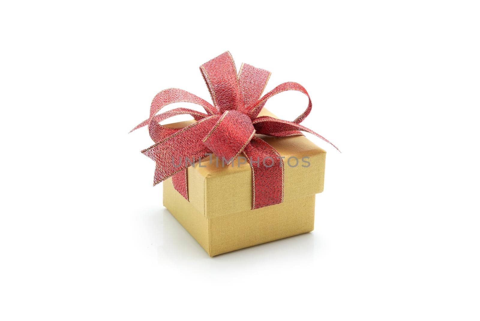 Gold gift box and ribbon isolated on white background, presents in valentine day or Christmas day, object in birthday or anniversary, package with wrap luxury, holiday and festive concept.