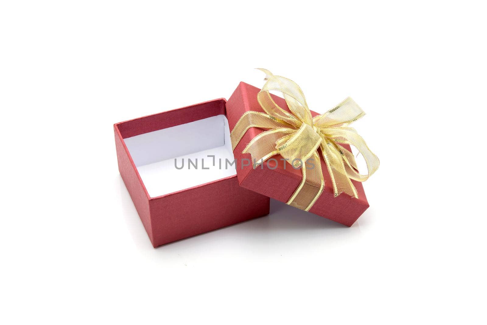 Red gift box and ribbon open isolated on white background, presents in valentine day or Christmas day, object in birthday or anniversary, package with wrap luxury, nobody, holiday and festive concept.