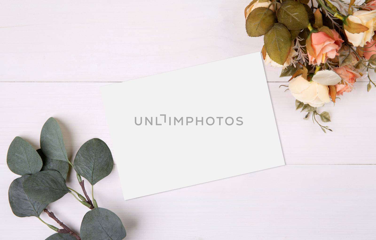 Valentine day, greeting card mockup and flower on wooden table, postcard blank and letter with romance on desk, present and paper in anniversary and celebration, top view, nobody, holiday concept. by nnudoo