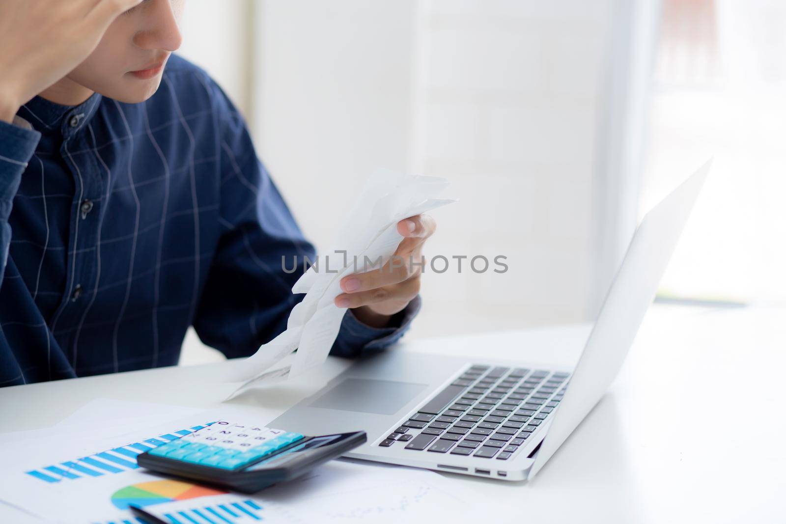 Young asian man calculating expenses household about finance and frustrated on desk at home, male checking bill having stress and worried, debt and tax, expression and emotion, business concept.