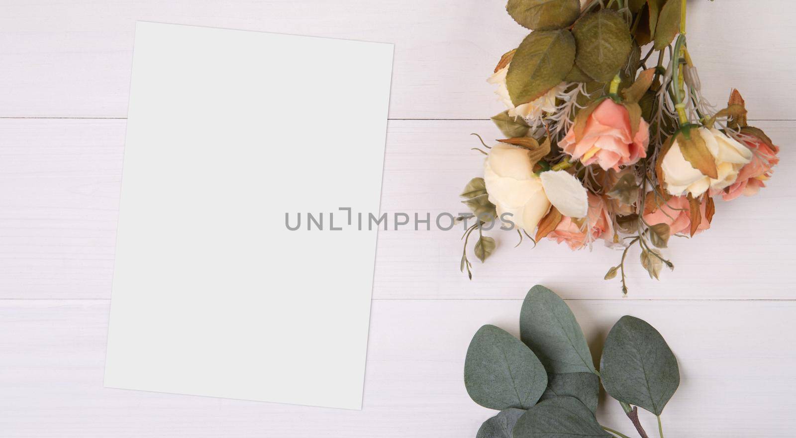 Valentine day, greeting card mockup and flower on wooden table, postcard blank and letter with romance on desk, present and paper in anniversary and celebration, top view, nobody, holiday concept. by nnudoo