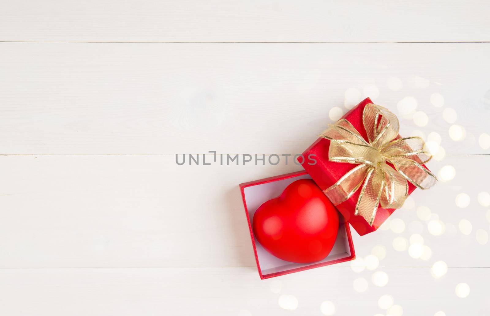 Valentine day, red gift box open put in heart with bokeh background, celebration and anniversary with giving love, donate and aid with heart shape symbol, charity and health, holiday concept.