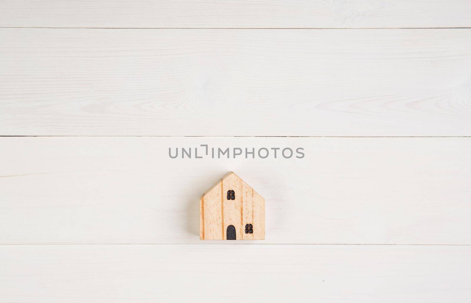 Model home small is wood on wooden background, real estate and investment and tax, mortgage and house, symbol investment for profit of asset, family and loan for residential, copy space.