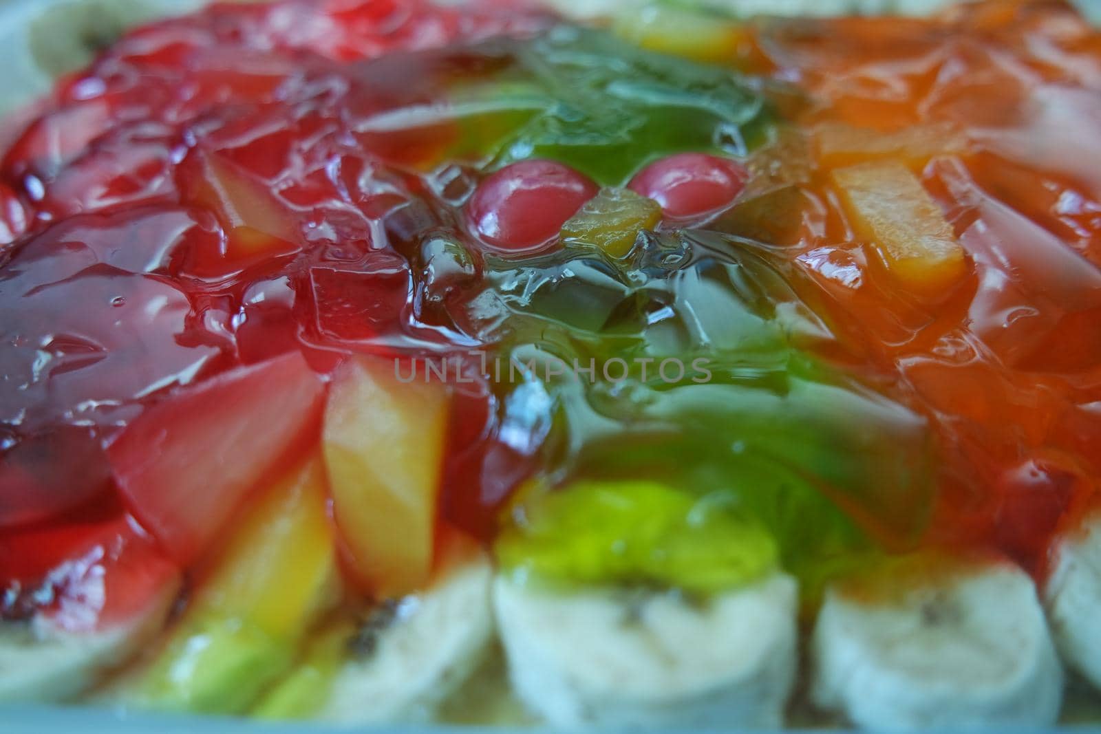 Creamy custard jelly sweet dish with different slices layered on surface by Photochowk