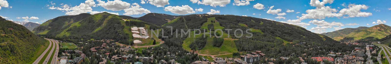 Vail city center and surrounding mountains, Colorado. Aerial view from drone in summer season by jovannig