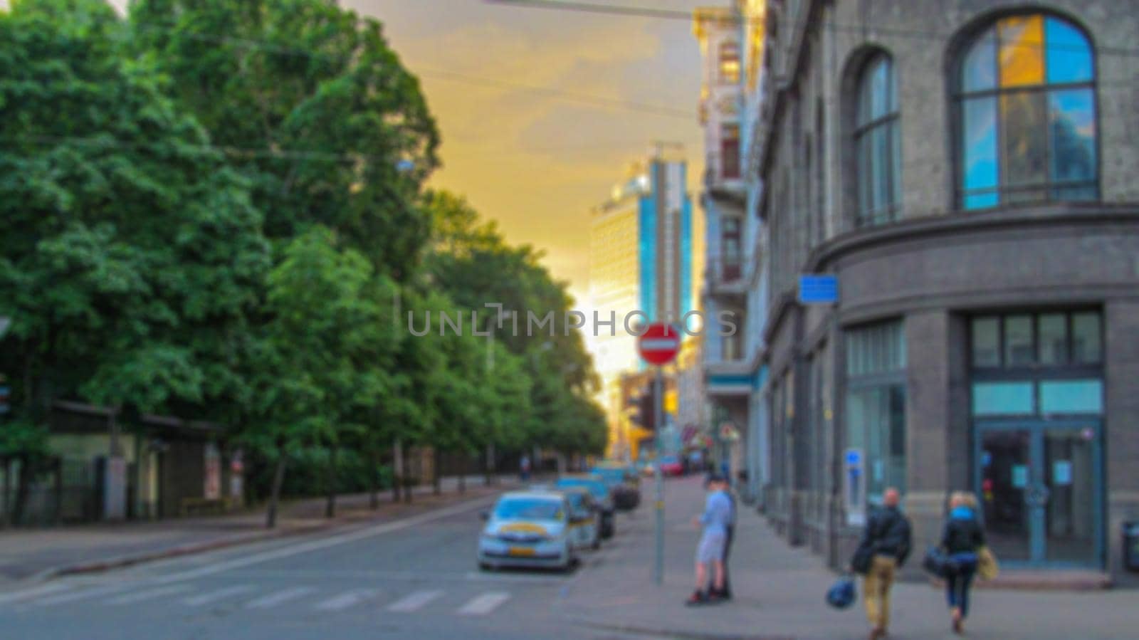 Blurred background of a city street. Urban landscape. Creative theme with blur and bokeh effect for backgrounds, posters and screensavers.