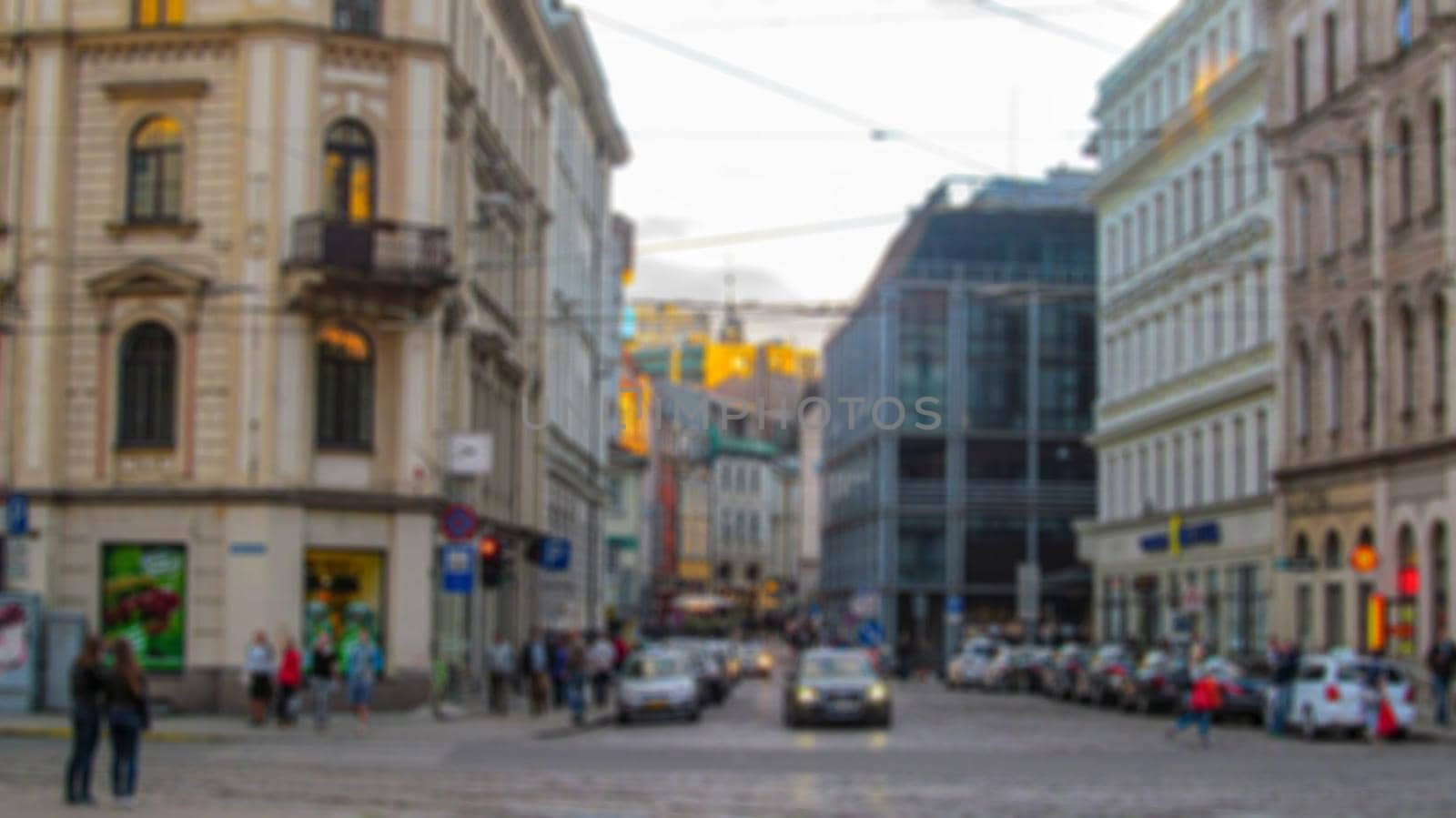 Blurred background of a city street. Urban landscape. Creative theme with blur and bokeh effect for backgrounds, posters and screensavers.