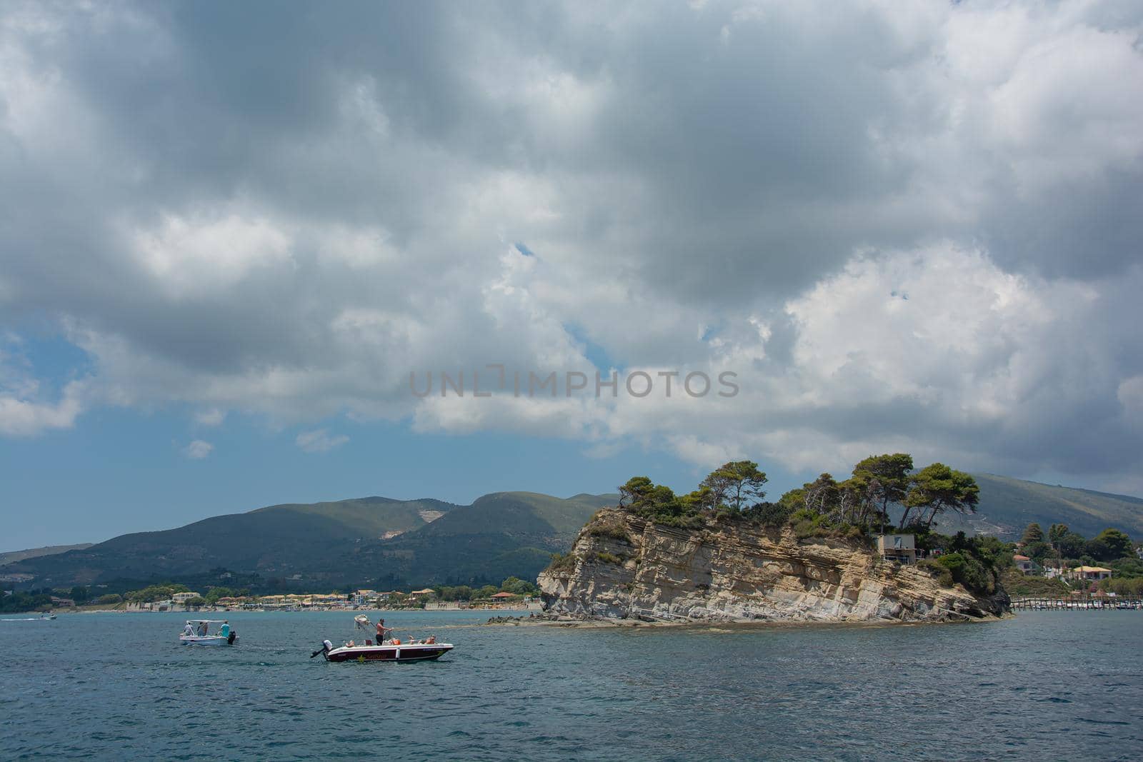 Laganas, Greece - 06/11/2016: Seascape. Motor boats with vacationers and tourists near the island