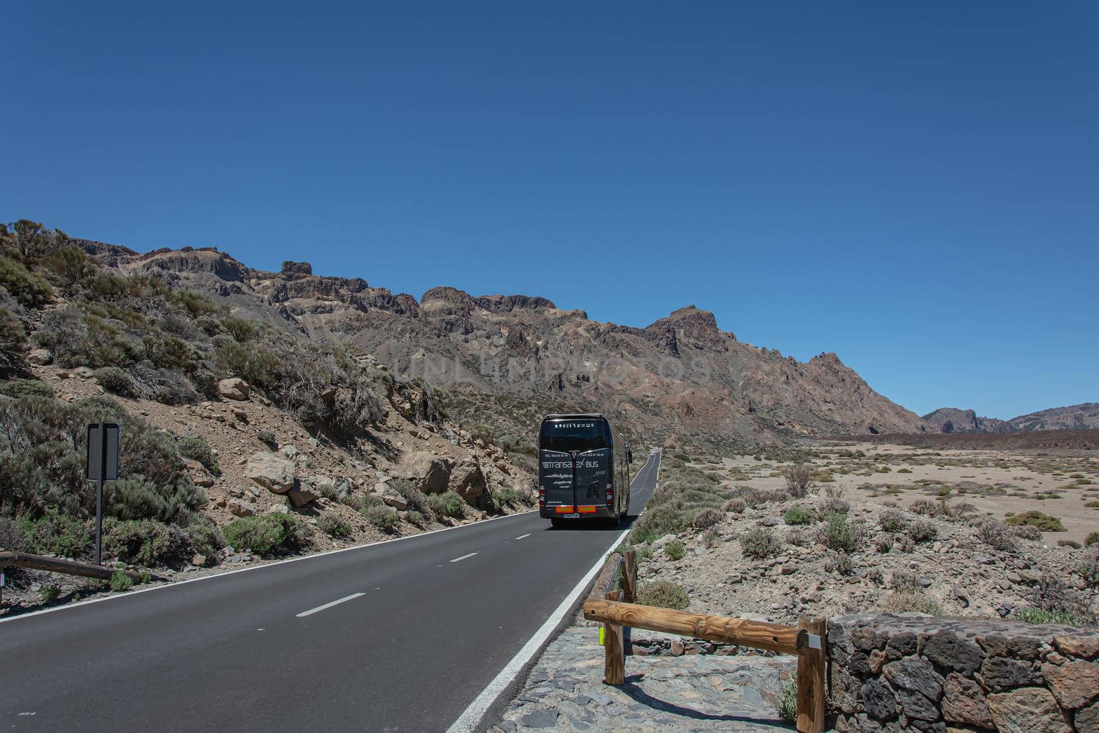 Tenerife island, Spain - 05/10/2018: Tourist bus rides on a mountain road by Grommik