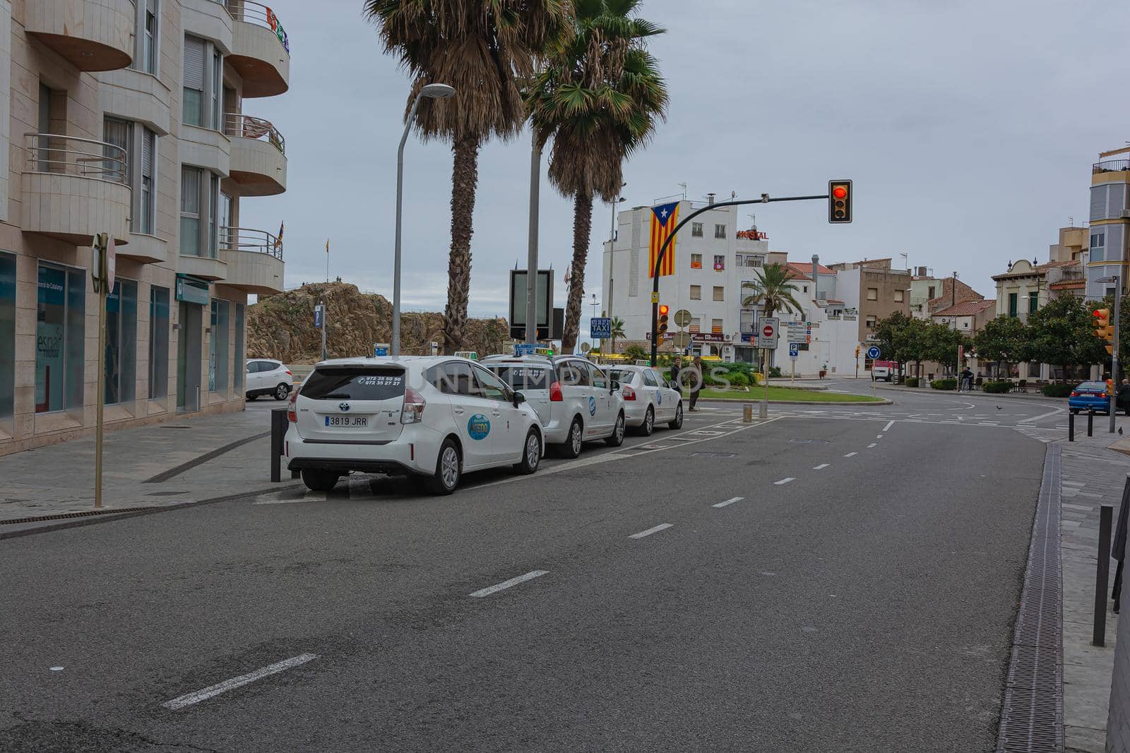 Spain, Blanes - 09/15/2017: taxi stand near the city square with circular traffic by Grommik