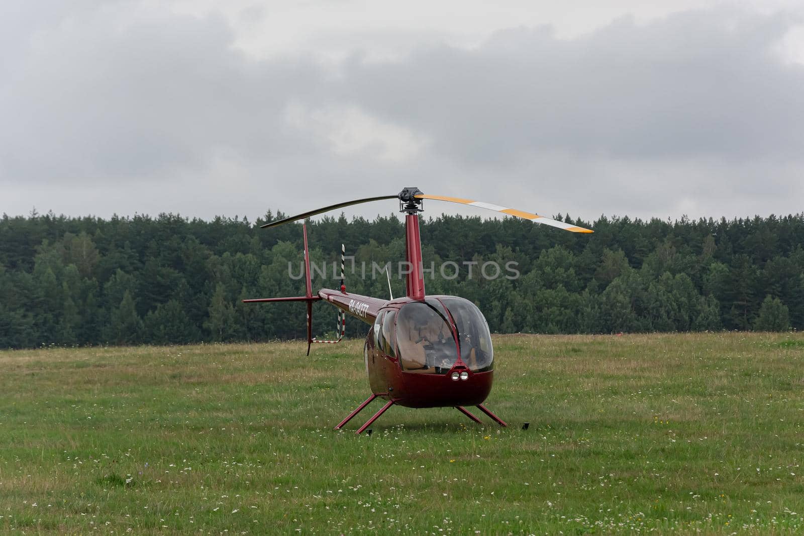 Minsk, Belarus - 07/25/2018: Helicopter on the green lawn of the airfield by Grommik