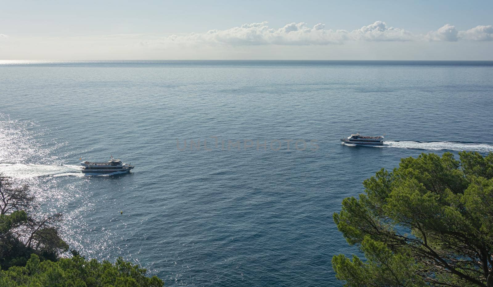 Lloret De Mar, Spain - 10/02/2019: Two pleasure craft on opposite courses. Stock photo.