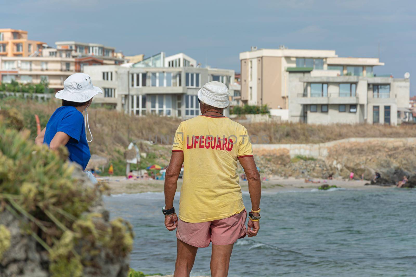 Sozopol, Bulgaria - 09/06/2018: A man in a t-shirt with the inscription lifeguard by Grommik