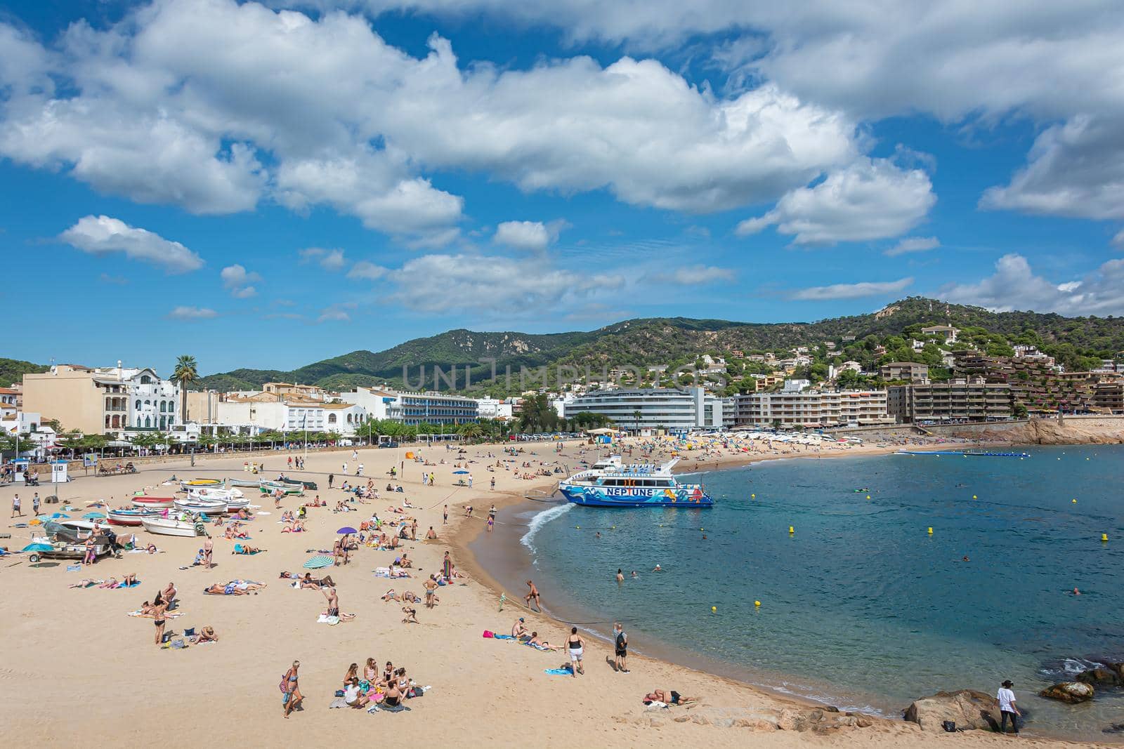 Tossa, Spain - 09/19/2017: city beach and pleasure boat by Grommik